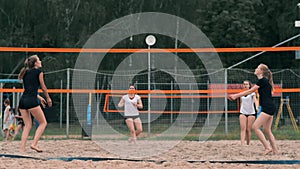 Woman volleyball serve. Woman getting ready to to serve the volleyball while standing on the beach slow motion.