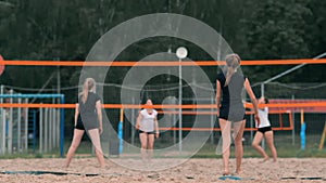 Woman volleyball serve. Woman getting ready to to serve the volleyball while standing on the beach slow motion.