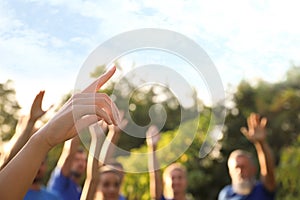 Woman at volunteers meeting. Group of people outdoors