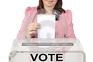 Woman voter in a smart pink jacket lowers a blank ballot in a transparent ballot box, concept of state elections, referendum