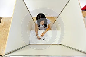 Woman in a voting booth