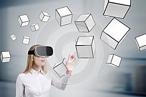 Woman in vr glasses and floating cubes