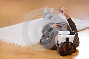 Woman with vr glasses on the floor