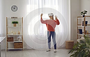 Woman in VR glasses touches augmented reality objects interacting with 3d simulation.