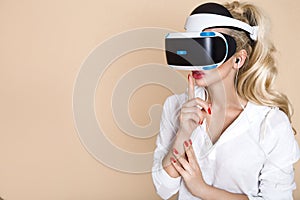 Woman with VR glasses of virtual reality. Young girl in virtual augmented reality helmet. VR headset.