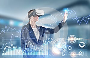 Woman in VR glasses working with infographics, hud