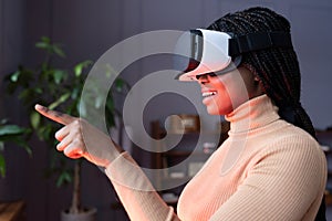 Woman in vr headset touch object in virtual reality. Girl in goggles interact in digital interface