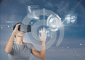 Woman in VR headset touching interface against blue sky with stars