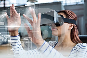 Woman in VR headset touching interfaces photo