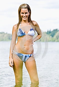 Woman wading in lake photo