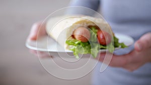 Woman Waiter Brings Plate Juicy American Hot Dog with Sausages and Lettuce Leave