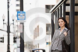 Woman waiting at bus stop