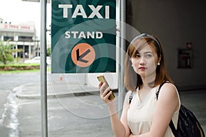 A woman is waiting for a cab