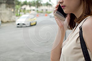 A woman is waiting for a cab