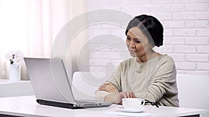 Woman waiting for email respond from children, online booking and shopping