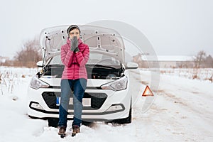 Woman waiting for help or assistance - winter car breakdown