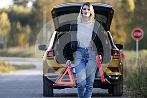 A woman waiting for roadside assistance.