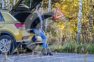 A woman waiting for roadside assistance.