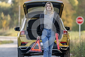 A woman waiting for roadside assistance.