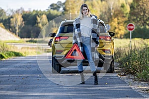 A woman waiting for roadside assistance.