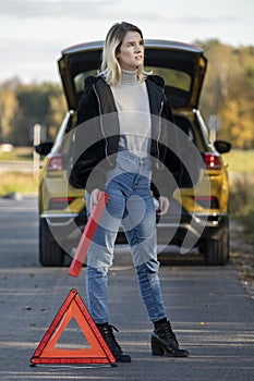 A woman waiting for roadside assistance.