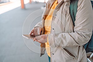 Woman waiting on station platform on background light train using smart phone. Tourist texting message and plan route of