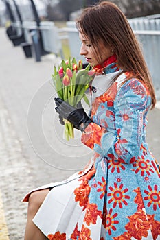 Woman waiting train look at flowers