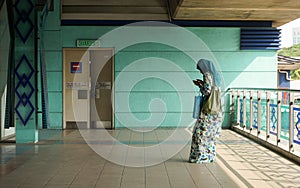 A woman waiting at the train station in Kuala Lumpur, Malaysia