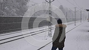 Woman waiting the train in winter.
