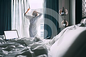 Woman wakes up in luxus hotel room