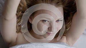 Woman waking up on bed