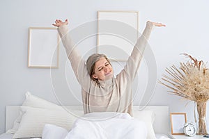 Woman waking up at bed at home