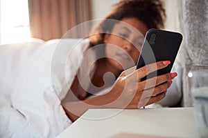 Woman Waking Up In Bed Immediately Reaches Out To Look At Mobile Phone