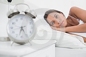 Woman waking up early in bed