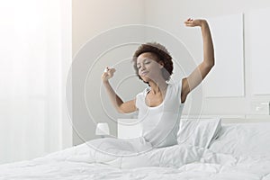 Woman waking up and stretching