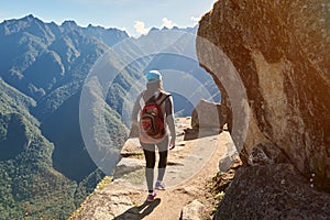 Woman walk on narrow mountain path photo