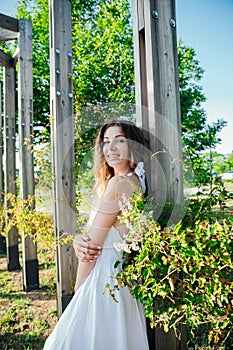 a woman on a walk near a wooden structure in the park