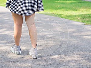 Woman walk solely under tree shade