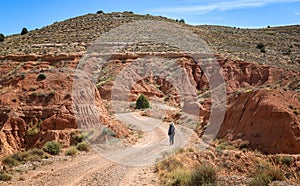 Woman walking Across Muela de Teruel Mountain