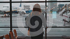 Woman walking in airport terminal.