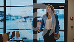 Woman walking in airport terminal.