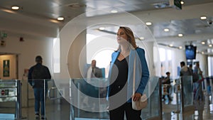 Woman walking in airport terminal.