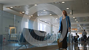 Woman walking in airport terminal.