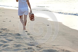 Woman walking alone on the beach