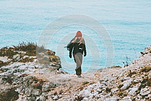 Woman walking alone at cold sea winter beach Travel Lifestyle concept