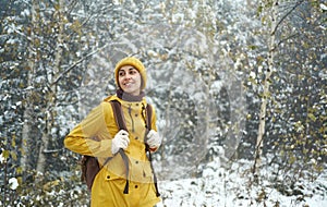 Woman walking alone in winter forest, enjoying wilderness. Winter is coming