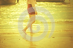 Woman walking along the beach