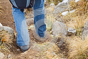 Woman walking along a mountain footpath