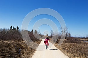 Woman walking along a nature trail