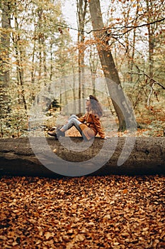 Woman walking in the autumn forest